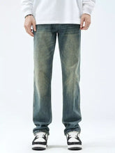 Men’s washed blue denim straight leg jeans with faded distressing and a classic straight leg cut