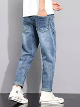Blue denim men’s washed straight leg jeans with a relaxed fit and rolled cuffs in straight leg style