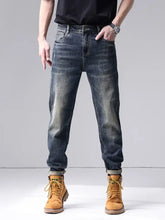 Men’s dark-wash slim-fit denim jeans with rolled cuffs in a washed straight leg style