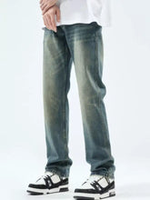 Men’s washed straight leg jeans in distressed blue denim with a faded worn-in look and classic straight leg cut