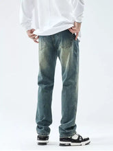 Men’s distressed blue denim washed straight leg jeans with classic five-pocket design and faded worn-in look