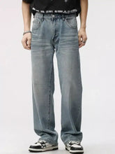 Men’s washed wide leg jeans in light-wash denim with a relaxed straight-leg cut and classic five-pocket design