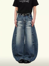 Men’s washed wide leg jeans in faded blue denim with prominent stitching details and a relaxed fit wide leg design