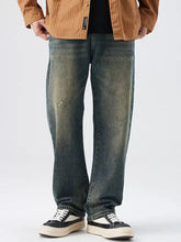 Men’s washed wide leg jeans in distressed dark wash denim with a relaxed straight-leg cut visible from the back side