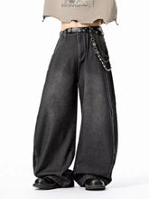 Men’s black washed wide leg jeans with distressed faded finish and decorative chain detailing on the belt