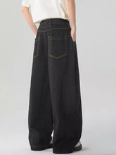 Men’s washed wide leg jeans back side featuring black denim with contrasting light stitching on the back pockets