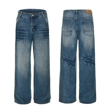 Men’s washed blue denim wide leg jeans with distressed ripped details on the thighs