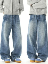 Men’s washed wide leg jeans in blue denim with a faded distressed look and subtle whiskering details