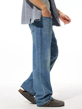 Men’s wide leg jeans in blue denim with a relaxed straight-leg cut and subtle fading for casual wear