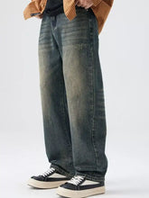 Men’s dark-wash wide leg denim jeans with a faded, distressed look and subtle thigh fading