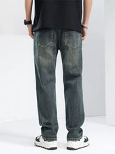 Men’s dark-wash denim washed wide leg jeans with relaxed fit and classic back pockets shown from the back side