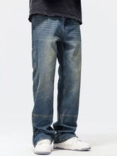 Men’s washed denim wide leg jeans in dark wash with relaxed straight-leg cut and visible stitching details