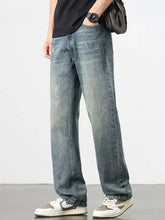 Men’s distressed blue denim wide leg jeans with straight-leg cut and faded wash for casual wear