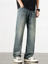 Distressed medium-wash denim men’s washed wide leg jeans with a relaxed straight-leg cut and wide leg design