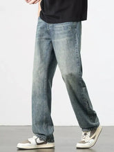 Men’s distressed medium-wash denim wide leg jeans with a relaxed straight-leg cut and casual style