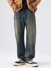 Men’s washed wide leg jeans in faded distressed denim with a straight-leg cut and classic blue wash