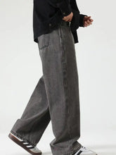 Men’s washed wide leg jeans in gray denim with a faded wash and classic stitching details on the back side