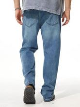 Men’s light-wash blue denim wide leg jeans with relaxed fit and classic back pockets shown from the back side