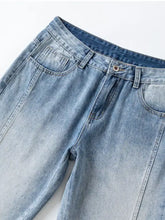 Men’s light-wash wide leg jeans in denim with a faded distressed look and classic five-pocket design