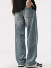 Mens washed wide leg jeans in light-wash denim with relaxed fit and classic back pockets shown from the back side
