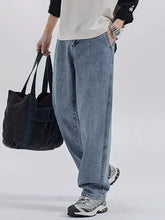 Men’s washed wide leg jeans in light-wash denim with a relaxed fit and subtle fading