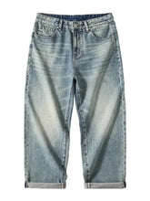 Men’s washed wide leg jeans in light-wash denim with a relaxed straight-leg cut and rolled cuffs