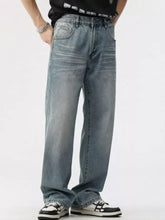 Men’s washed wide leg jeans in light-wash denim with a relaxed straight-leg cut and subtle fading for a modern casual look