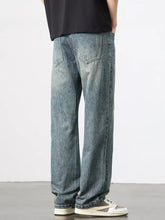 Men’s light-wash denim wide leg jeans with a relaxed straight-leg cut and subtle fading for a casual modern look