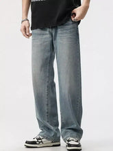 Men’s washed wide leg jeans in light-wash denim with a relaxed straight-leg cut and visible stitching details