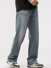 Men’s washed wide leg jeans in light-wash denim with a straight-leg cut and subtle fading