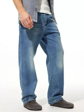 Men’s medium-wash blue denim wide leg jeans with relaxed straight-leg cut and classic five-pocket design