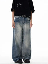 Men’s washed wide leg relaxed fit jeans in faded distressed denim with rolled cuffs and a relaxed silhouette