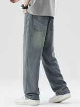 Men’s washed wide leg relaxed fit jeans in faded gray denim with classic front pockets and a relaxed fit