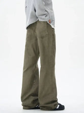Men’s wide leg flare jeans in olive green denim with a relaxed fit and classic back pockets shown from the back side