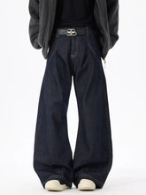Men’s dark blue wide leg jeans in denim with a black belt featuring a silver double b buckle