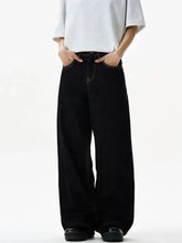 Black wide leg denim jeans with contrasting light stitching showcasing men’s wide leg jeans style