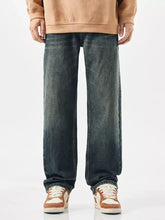 Men’s wide leg jeans in dark-wash denim with a relaxed, straight-leg cut and subtle fading along the thighs