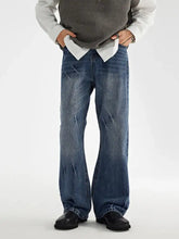 Men’s wide leg jeans in blue denim with a faded distressed finish and subtle whiskering details