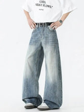 Men’s wide leg jeans in faded blue denim with subtle distressing details for a casual look