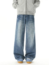 Men wide leg jeans in faded blue denim wash with subtle whiskering and frayed hems for a casual look