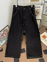 Men’s black denim wide leg jeans with subtle white stitching along the seams for a stylish casual look