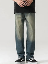 Men’s wide leg jeans in dark-wash denim with a faded distressed look and a straight-leg cut