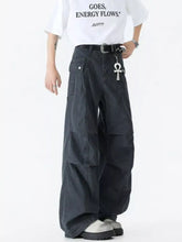 Men’s black wide leg cargo pants with multiple pockets and a studded belt buckle wide leg cargo style