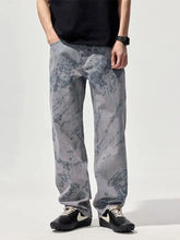 Men’s wide leg gray denim jeans with a marbled faded wash pattern showcasing a stylish casual look