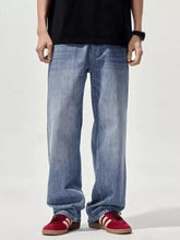 Men’s wide leg jeans in light-wash blue denim with a relaxed straight-leg cut displayed from the front