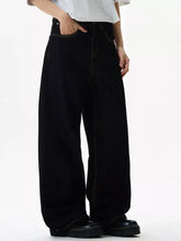 Men’s black wide leg jeans with contrasting light stitching and a high-rise waist in denim material
