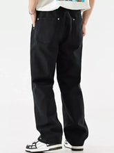 Black wide leg jeans in denim with a relaxed perfect fit and silver button details on the back pockets visible from the back side