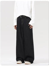 Men’s black wide leg jeans in denim with a relaxed fit and subtle stitching details