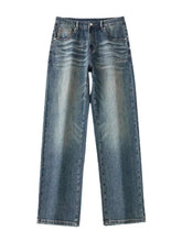 Men’s wide leg jeans in blue denim with a faded distressed wash and straight-leg cut