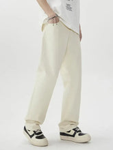Men’s cream-colored wide leg jeans in relaxed-fit cotton with straight-leg cut and subtle stitching details